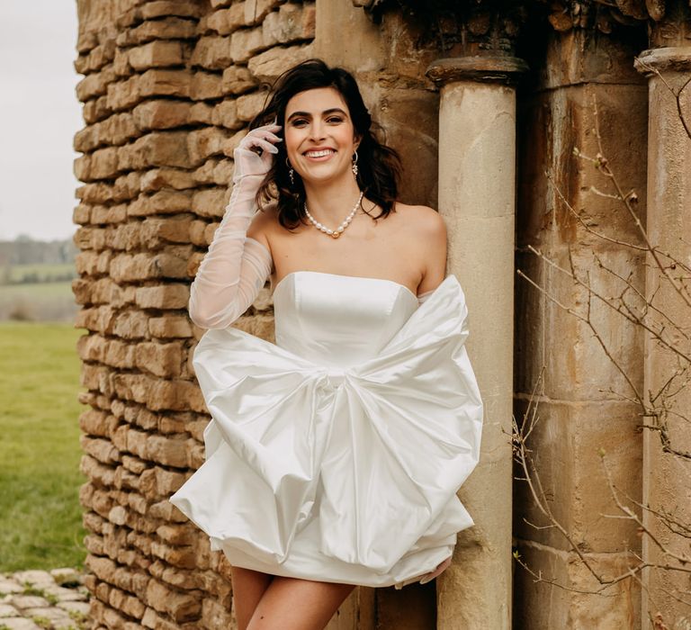 Bride in a short strapless wedding dress with giant bow detail 