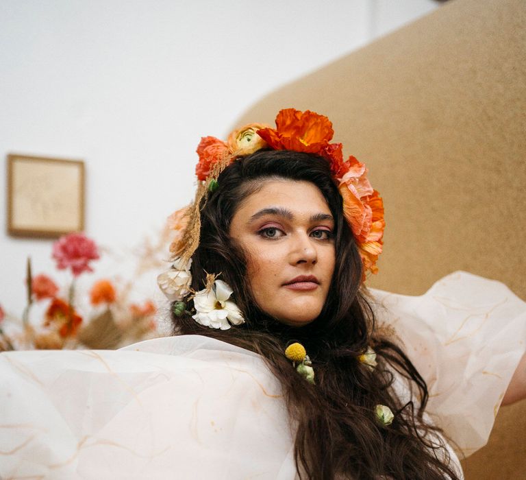 Bride wearing an orange and white fresh flower crown made up of poppies