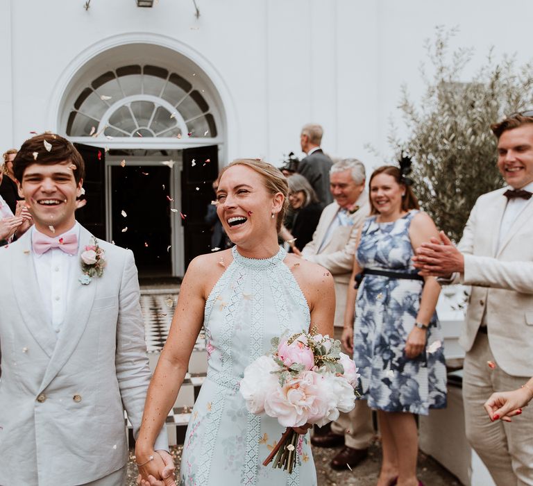 Bride & groom leave Belair House after wedding ceremony as they smile and laugh 