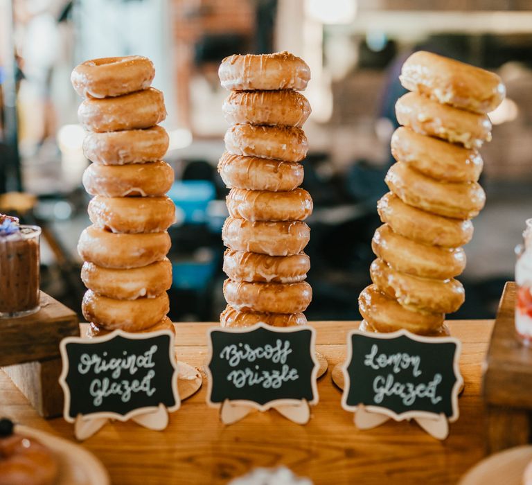 Dessert table complete with doughnuts and chalk board signs 