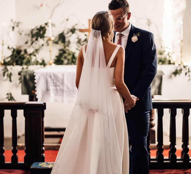 Bride and groom at church service before DIY marquee wedding