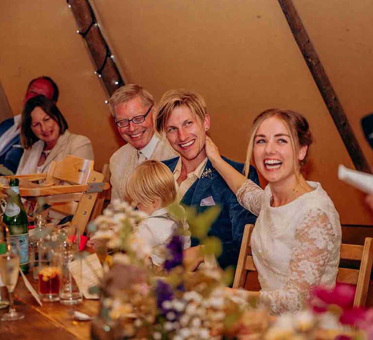 Bride and groom enjoy wedding speeches