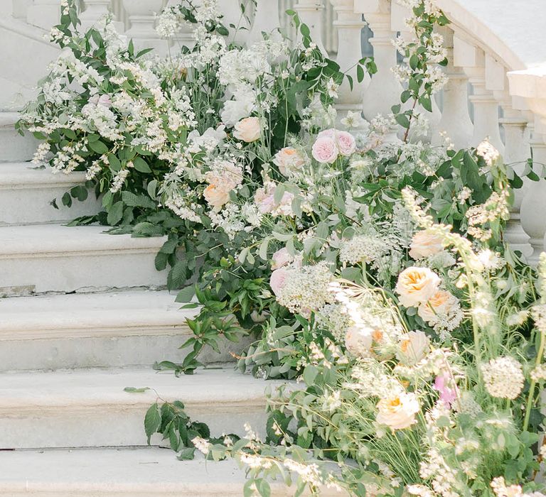 staircase wedding flowers at Botley's Mansion with roses, peonies, Icelandic poppies, sweet peas, scabious, foxglove, and snapdragons