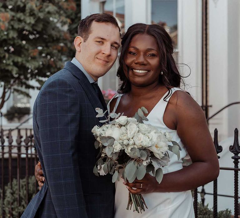 Bride & groom pose for post-wedding couples portraits outside in Chelsea