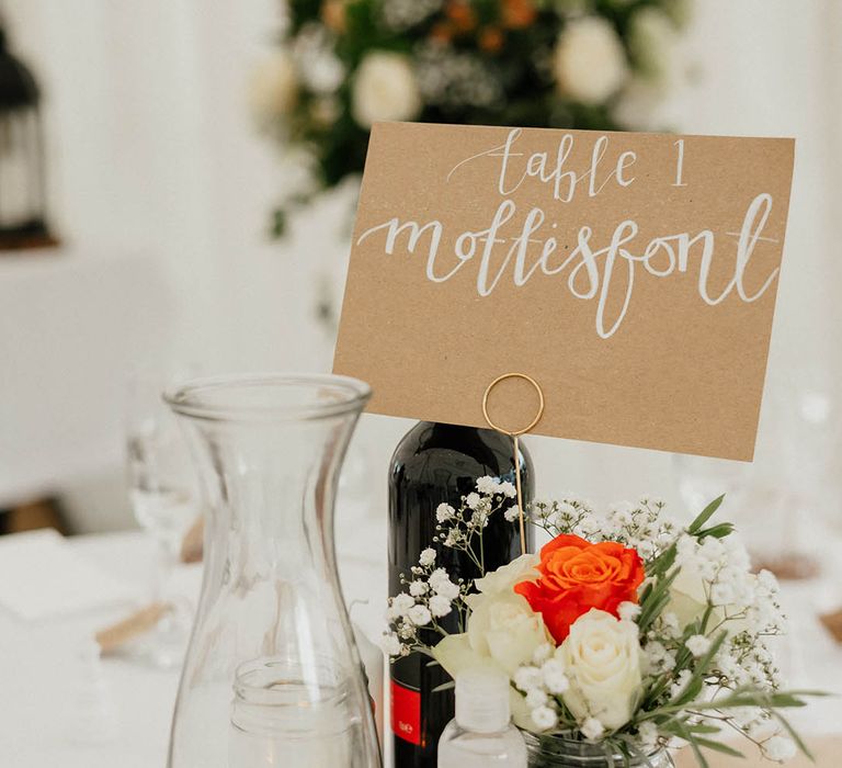 Table decor complete with wooden stand and different sized vases with florals inside