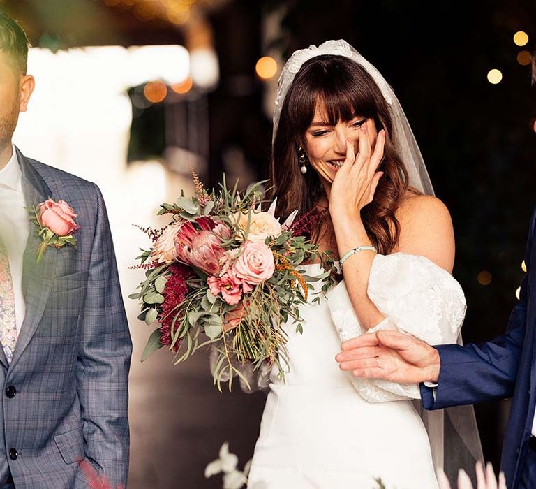 Father of the bride in a blue suit giving his daughter away at the altar 