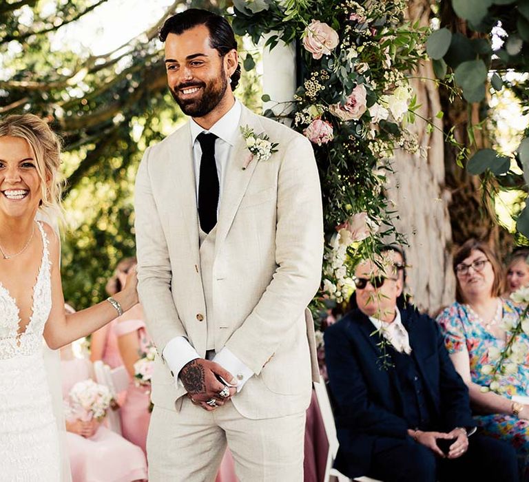 Bride and groom laugh during wedding ceremony