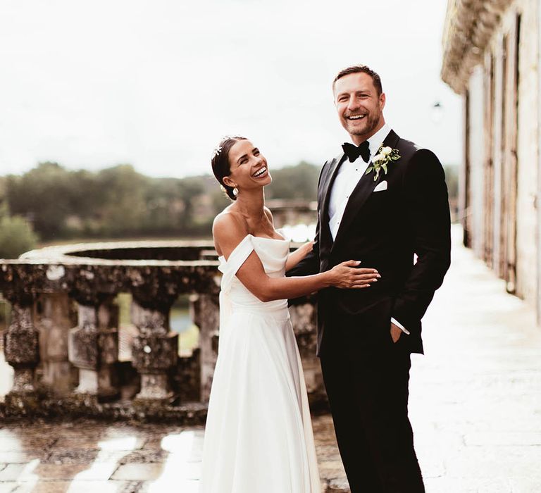 Bride & groom embrace outdoors on balcony 