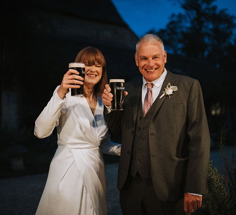 Bride has a pint with wedding guest