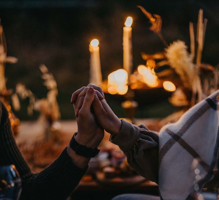 romantic campfire proposal with candles and fairy lights 