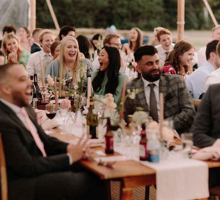 Wedding guests enjoy wedding speeches at White Pond Farm venue