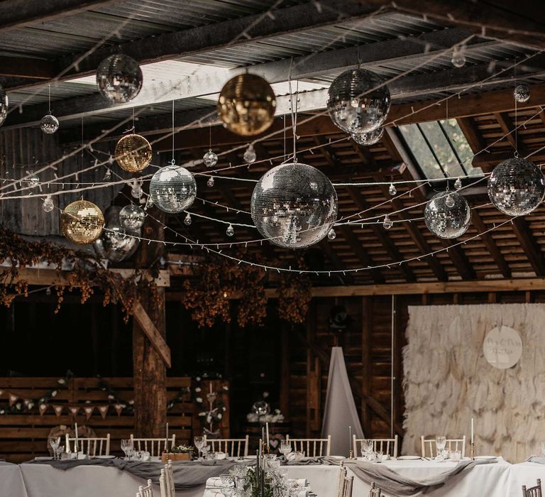 Rustic wedidng with hangind disco balls and fairy lights ceiling wedding decor