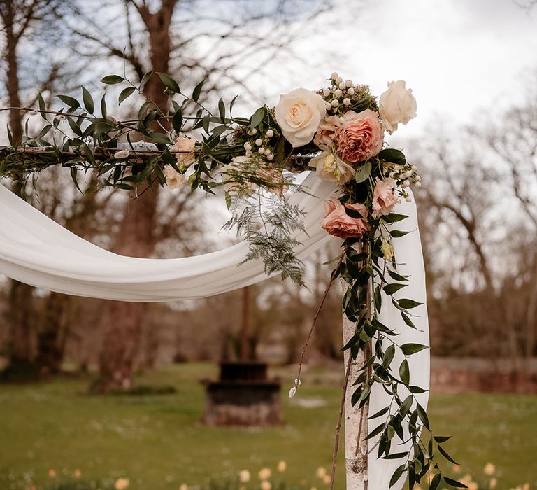 Wooden frame altar with drapes, roses and foliage decor 