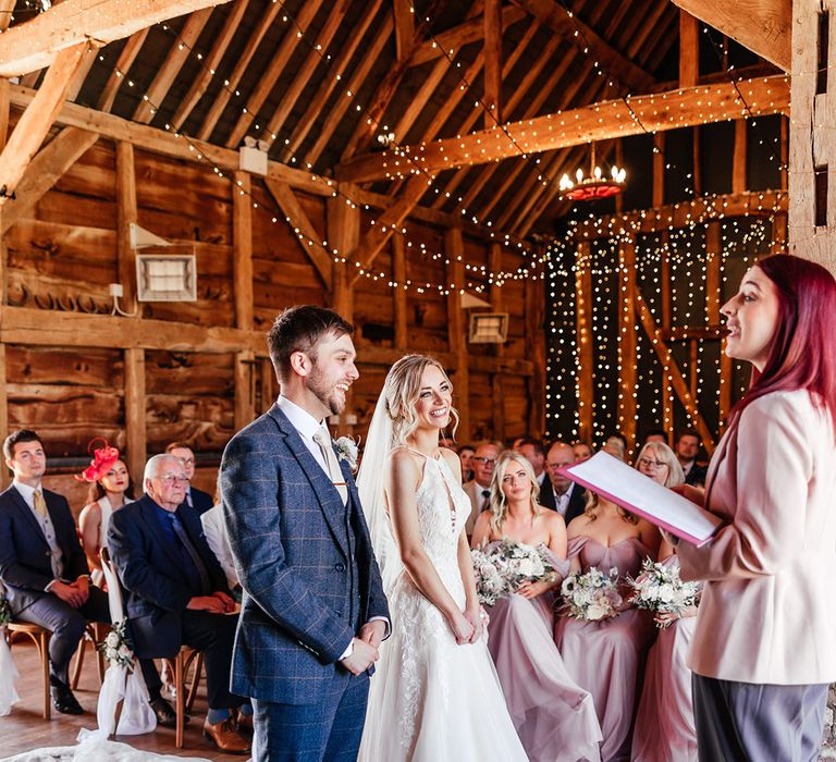 Bride and groom stand smiling together for their humanist wedding ceremony led by a celebrant 