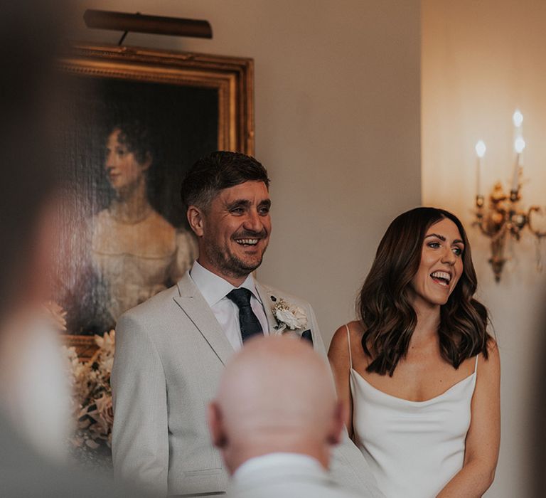 Bride and groom laugh during their intimate wedding ceremony 