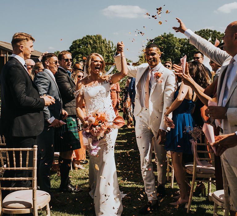 Bride and groom have confetti exit from their wedding 