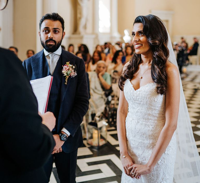 Bride & groom during wedding ceremony at Syon Park before reading personal vows