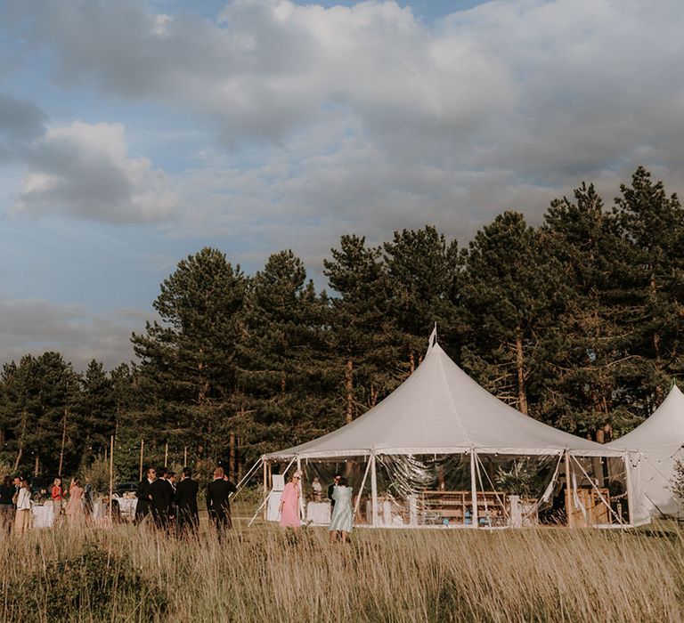 Cream marquee reception at the couple's friends home wedding 