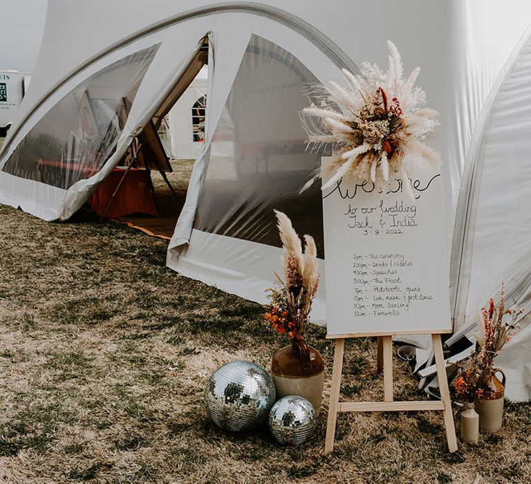 Welcome wedding sign on wooden easel complete with dried floral arrangements 