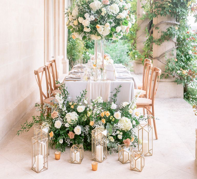 Yellow wedding flowers lay outside on the table for the al fresco dining 