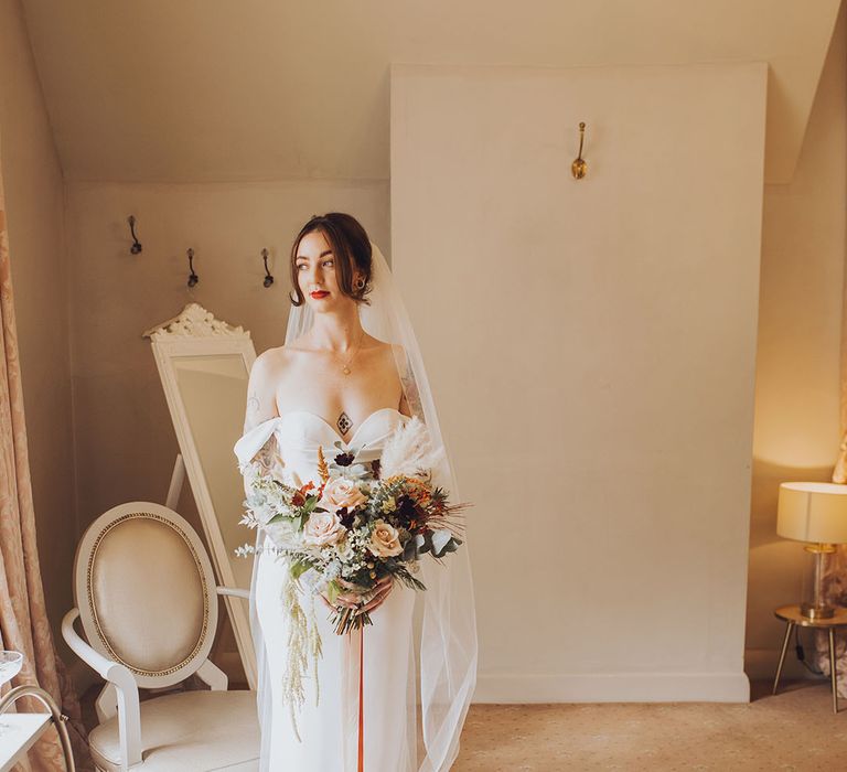 Bride in Vera Wang wedding dress with off-the-shoulder styling and sweetheart neckline 