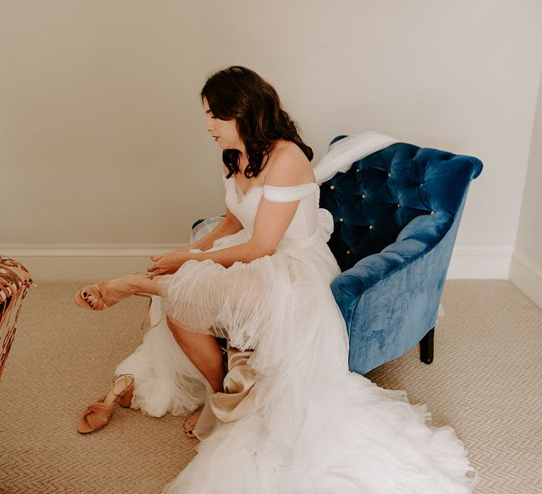 The bride puts on her pink Loeffler Randall wedding shoes for her Wilderness Reserve wedding