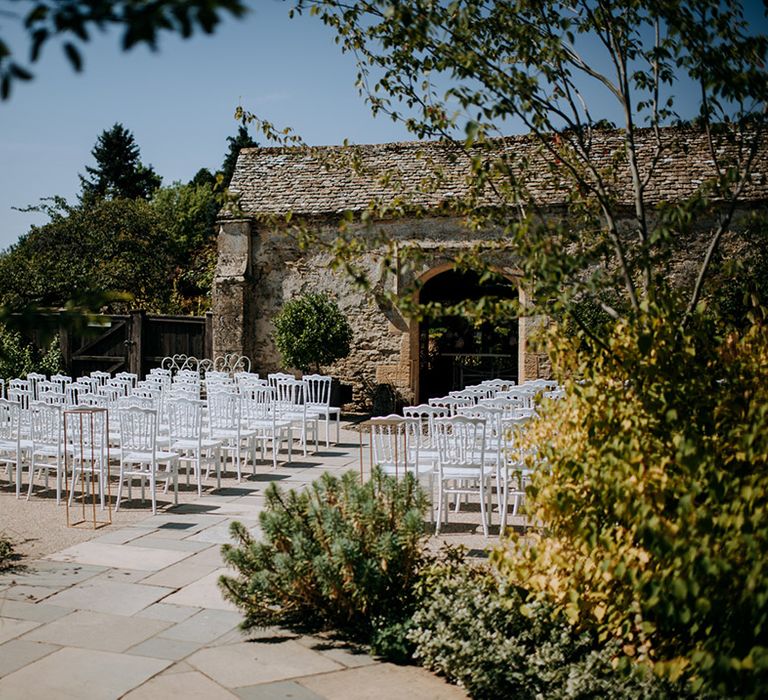 Outdoor wedding ceremony set up at Cotswolds wedding venue, Caswell House