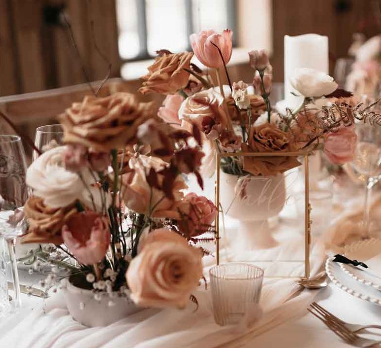 Wedding tablescape with toffee, nude and blush colour palette, soft linen table runners, gold cutlery and charger plates 