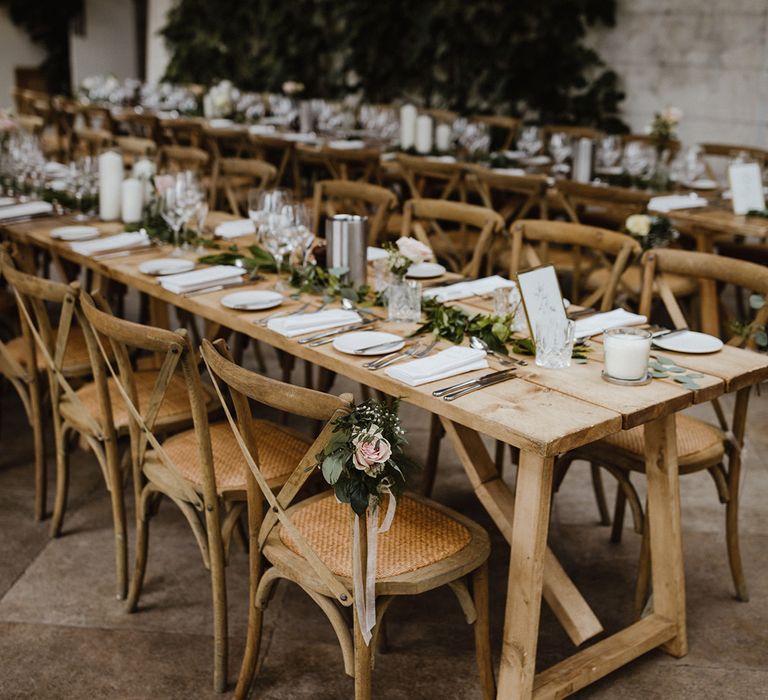 Middleton Lodge Estate wedding venue with long banquet tables with foliage table runner and white wedding menus and crockery 