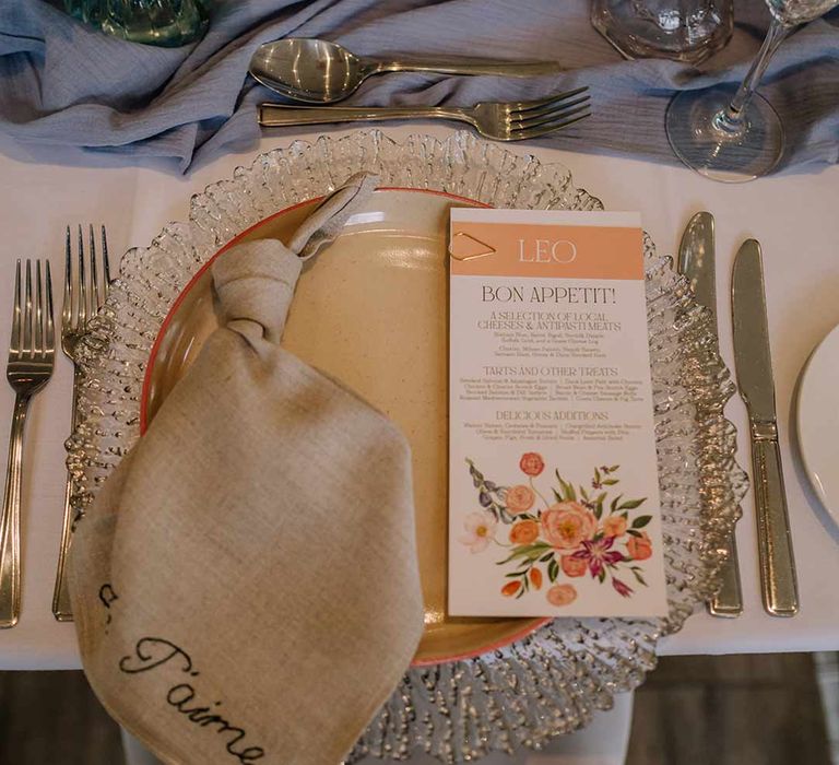 Classic wedding tablescape at Braxted Park wedding venue with white wedding tablecloth, cornflower blue wedding table runner, cream embroidered wedding napkin and botanical luxe wedding menu 