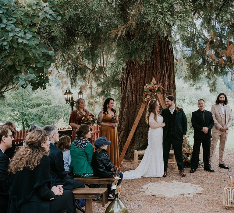 boho outdoor wedding ceremony with wicker mats 