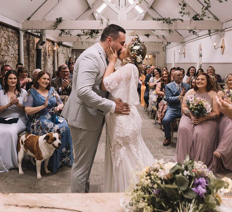 Bride in wildflower wedding crown for boho wedding with the groom in three piece light grey suit at Wyresdale Park 