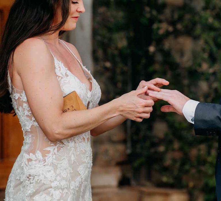 Bride and groom exchanging rings at intimate elopement ceremony at Giraffe Manor wedding venue in Kenya, East Africa 