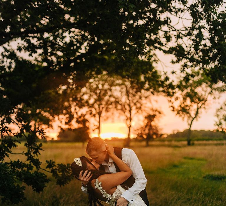 Stunning golden hour wedding portrait of the bride and groom at their classic black tie wedding day 