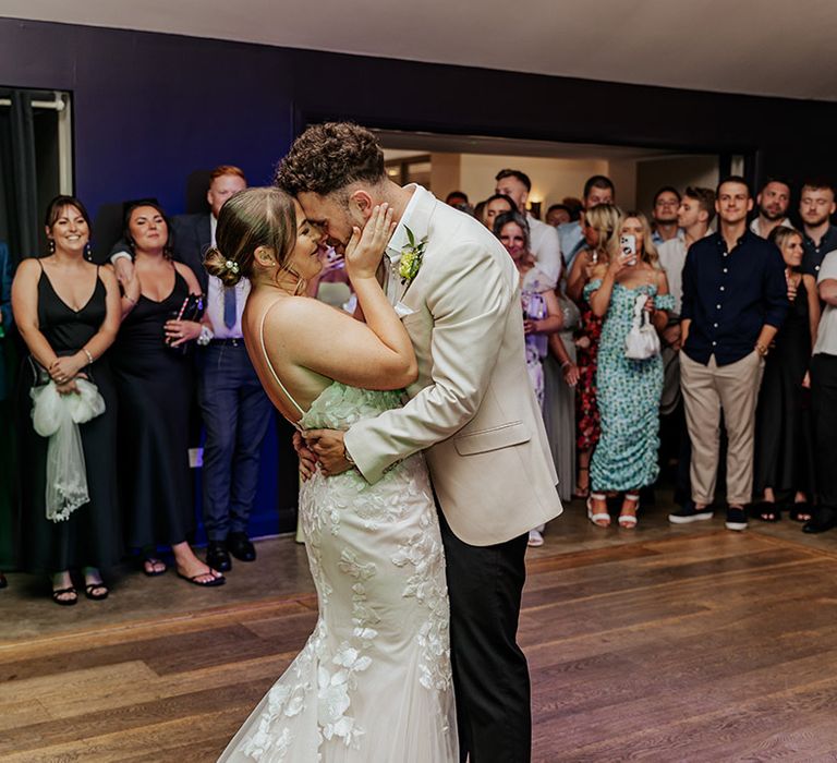 The bride and groom have their first dance together at barn wedding venue 