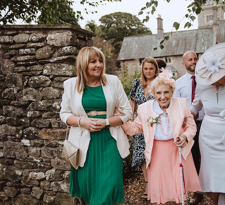 Wedding guests in pastel wedding outfits for the blush pink wedding at The Casterton Grange Estate 