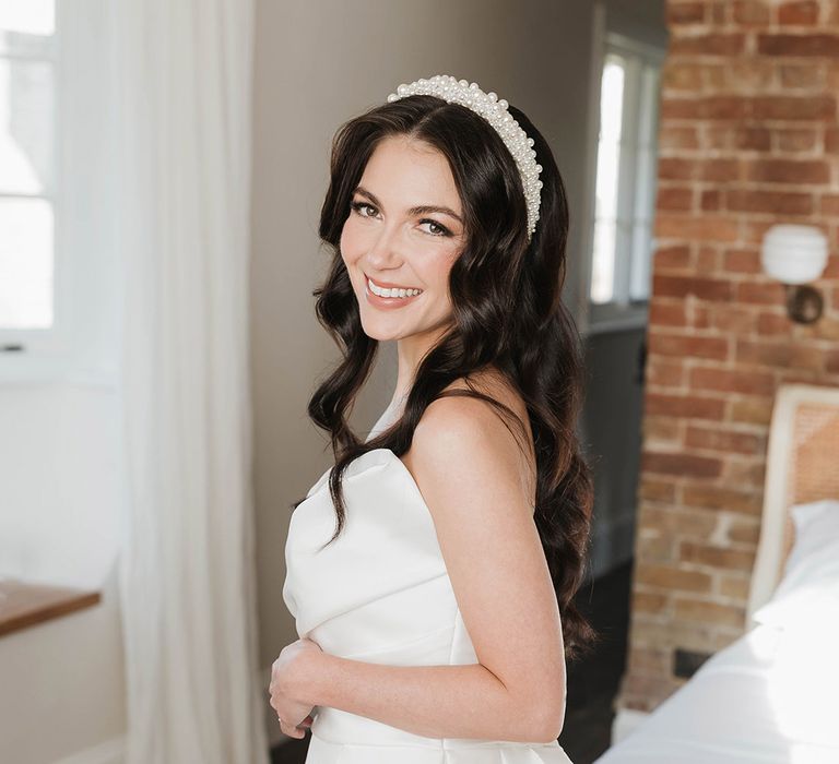 Beautiful winter bride in off the shoulder wedding dress by Pronovias with a peal wedding headband 