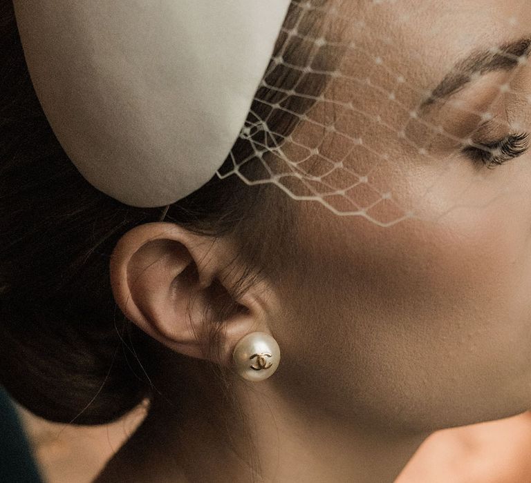 Bride wearing pearl Chanel earrings for her wedding 