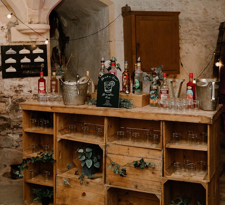 Rustic wedding bar design with different rums to acknowledge the groom's heritage 