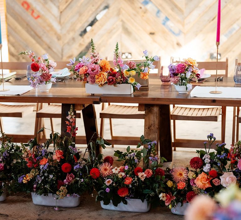 Colourful wedding flowers at The Canary Shed in white bowl arrangements decorating the tables