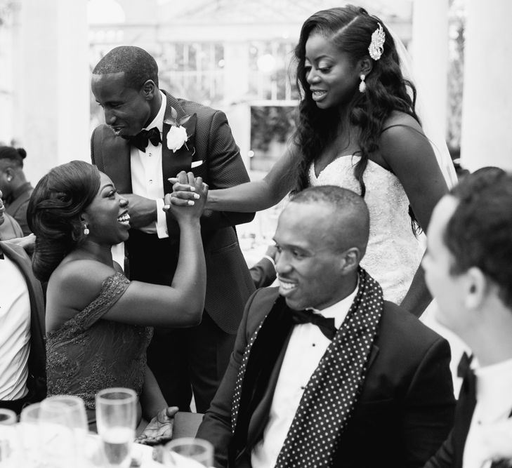 Bride and groom walking around their reception greeting guests 