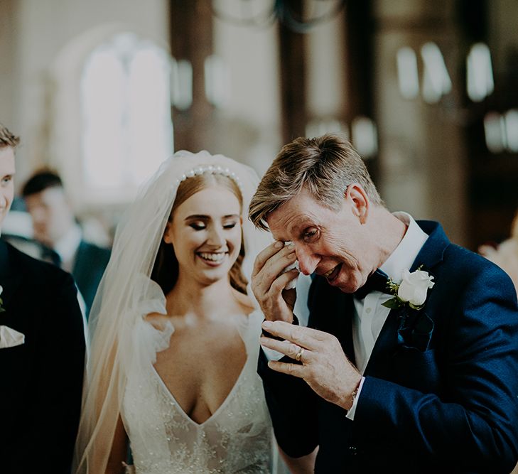 Emotional father of the bride during church wedding 