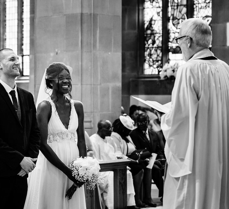 Bride and groom exchanging vows at St Nicholas Church in Liverpool