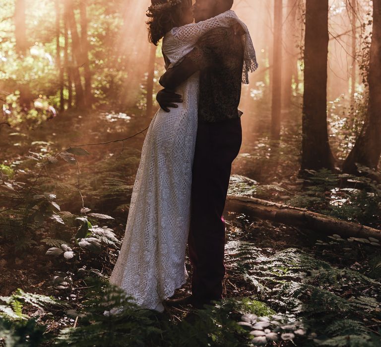 Bride & groom at Longton Wood with light streaming through trees 