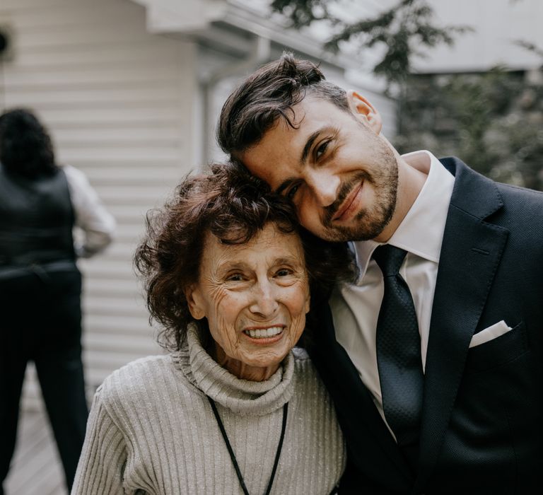 Groom poses with wedding guest