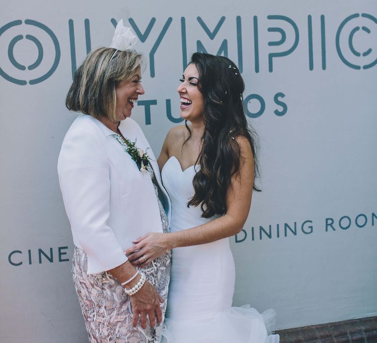 Bride laughing with mother of the bride 