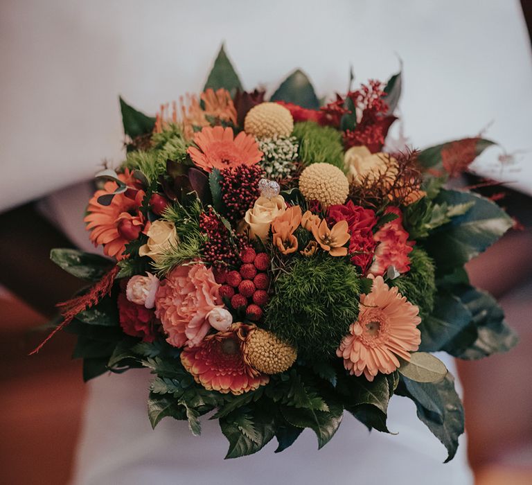 Autumnal bouquet featuring red and orange blooms