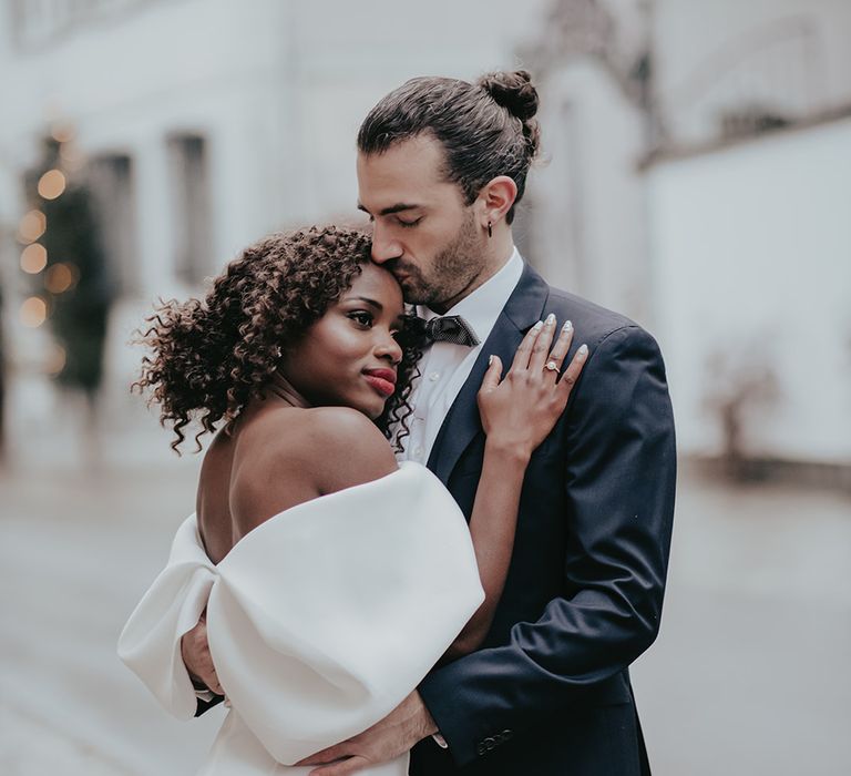 Bride & groom embrace outdoors