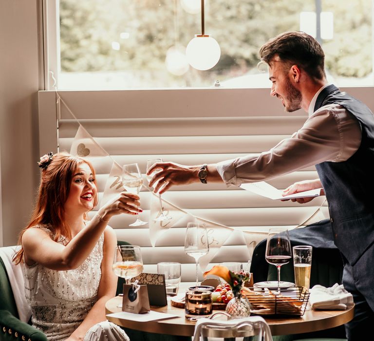 Bride cheers during wedding speech 