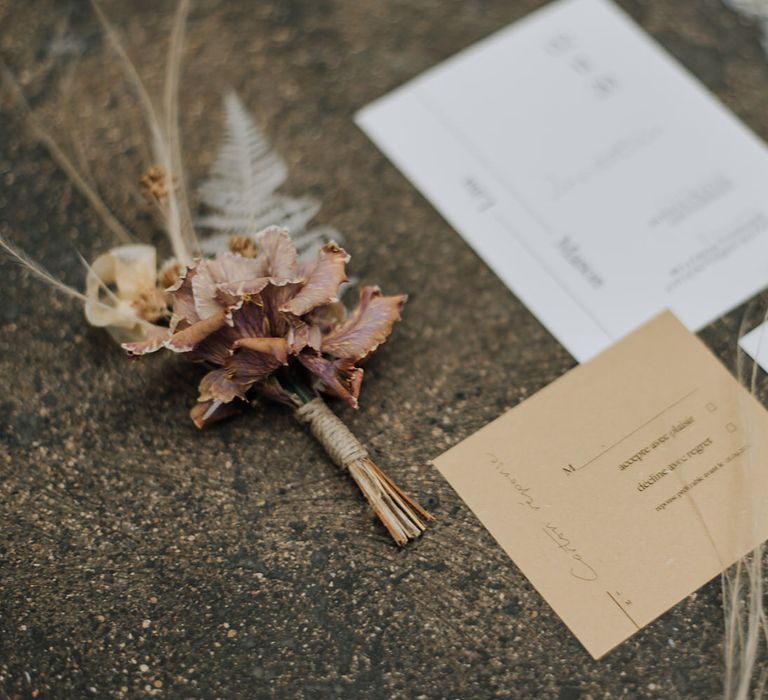 Minimal white and brown wedding invitations with dried flowers